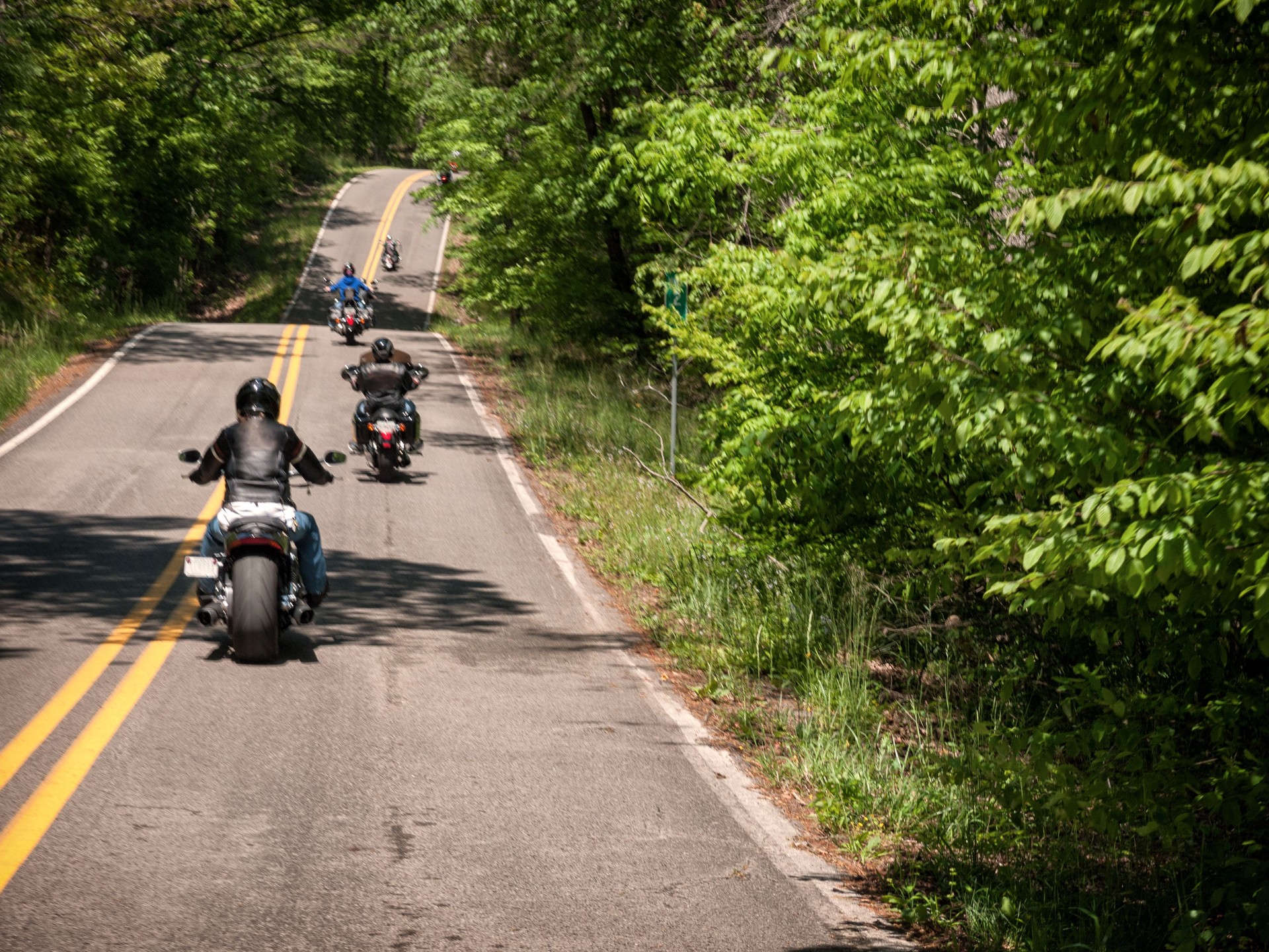 A motorcycle group ride through the countryside.